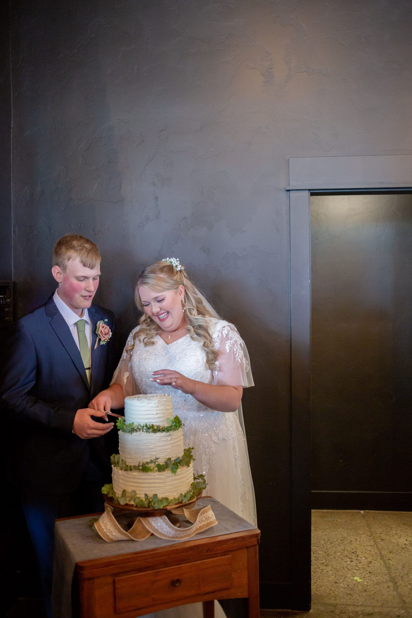 bride and groom cutting the cake