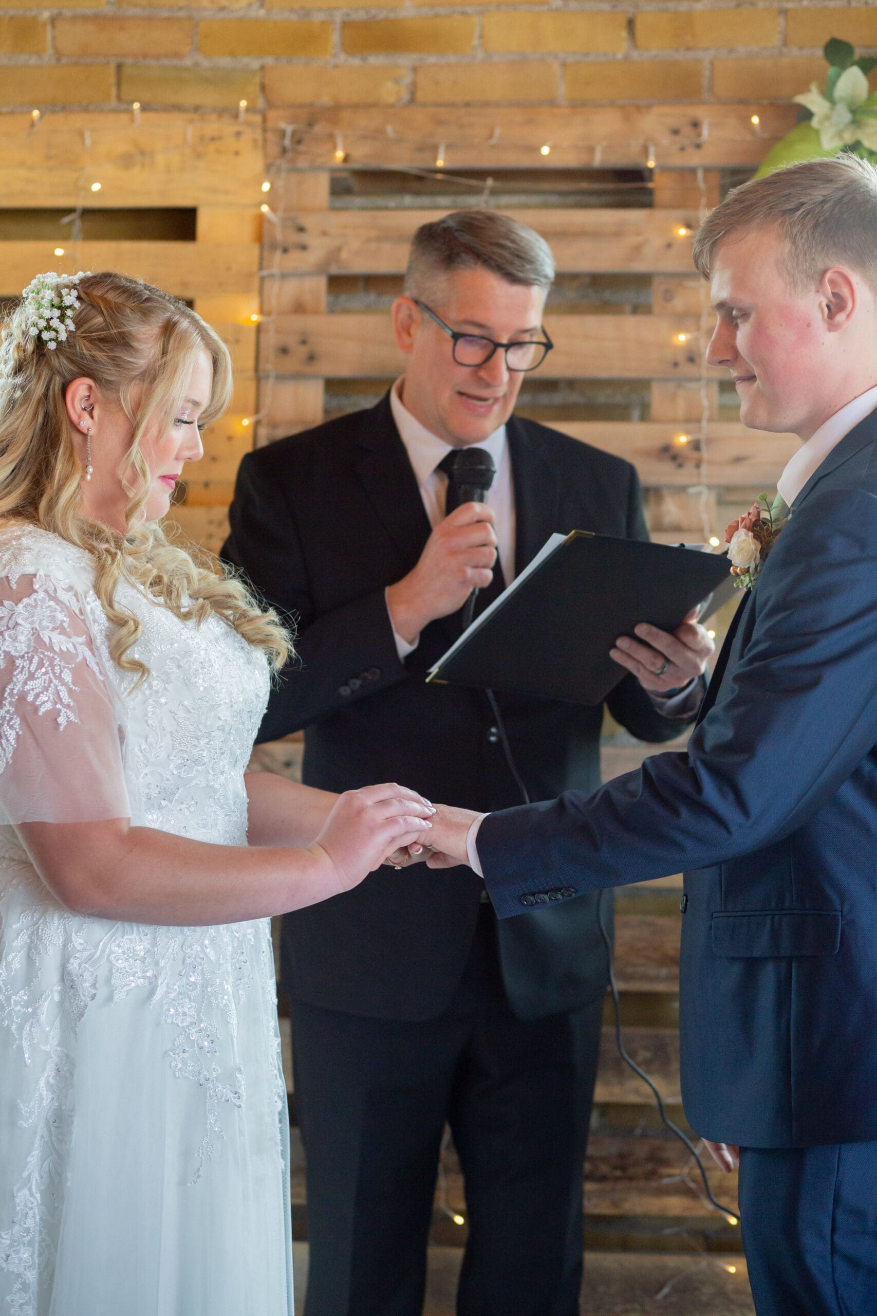 bride and groom exchanging rings - simple rigby idaho wedding