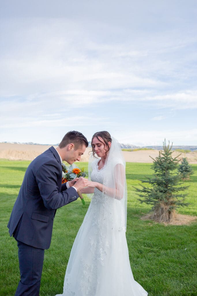 groom-putting-ring-on-his-bride