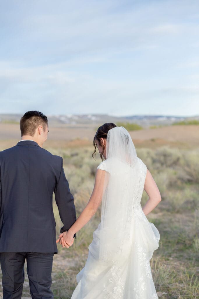 bride-and-groom-holding-hands-walking