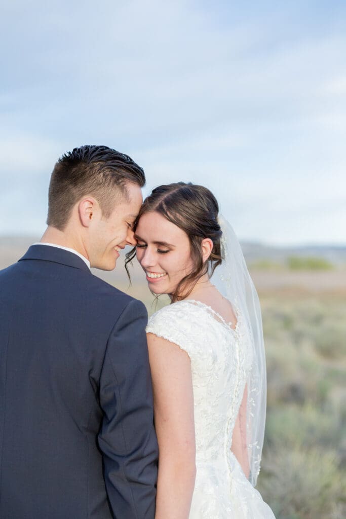 bride-and-groom-looking-down-with-shoulder-together
