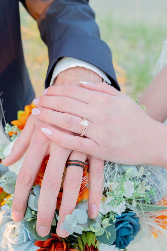 PNW Elopement Photographer captures bride with hand on top of groom's hand over bouquet