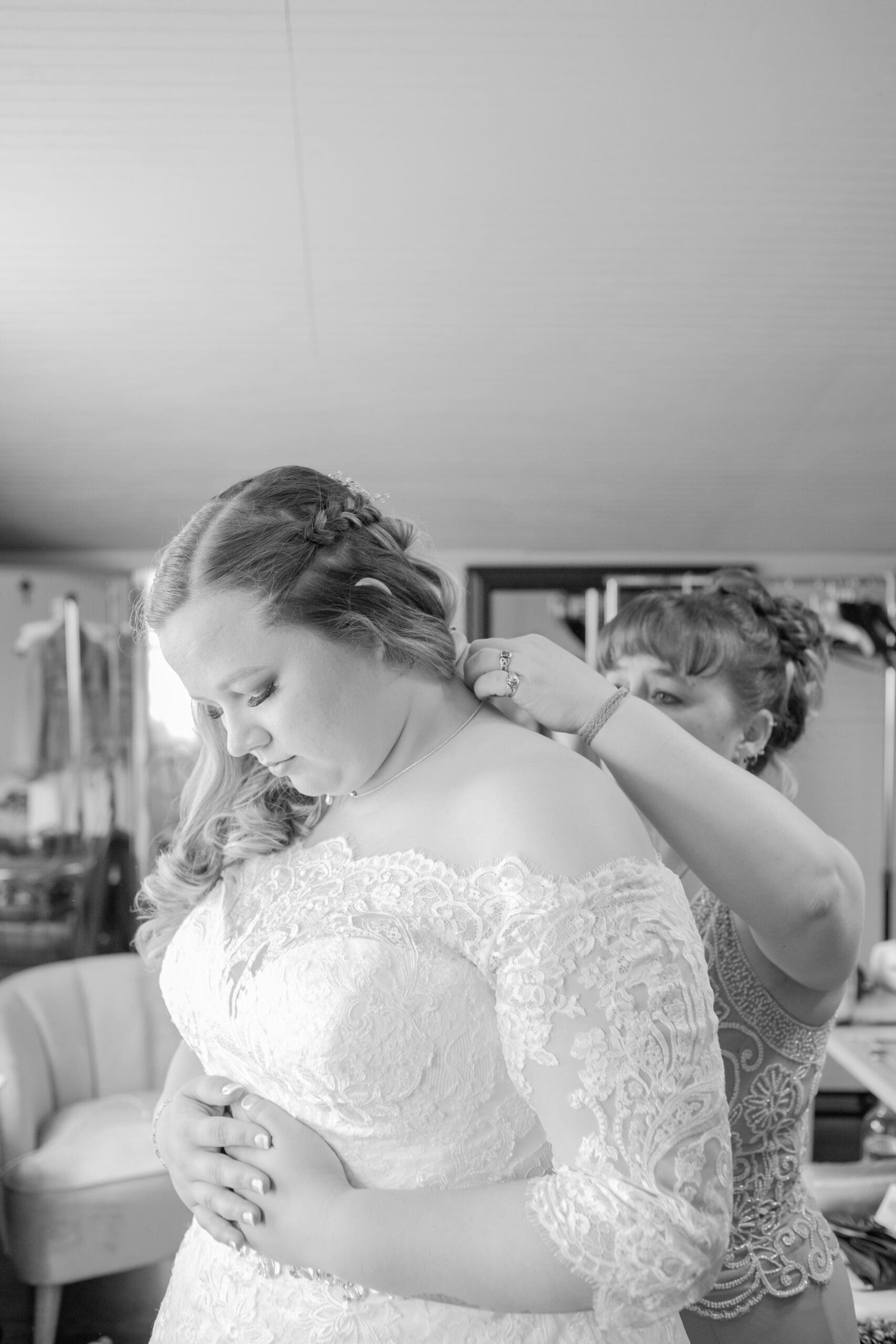 mother-of-bride-putting-on-brides-necklace