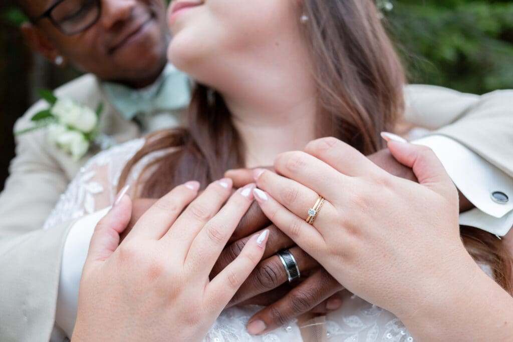 Close up of wedding rings on a hands of an inter-racial couple captured by a Wedding Photographer in Seattle WA