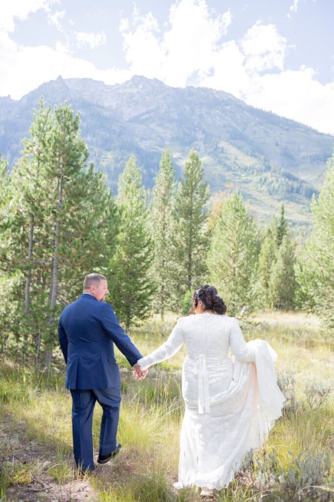 PNW Elopement Photographer captures couple walking into forest together
