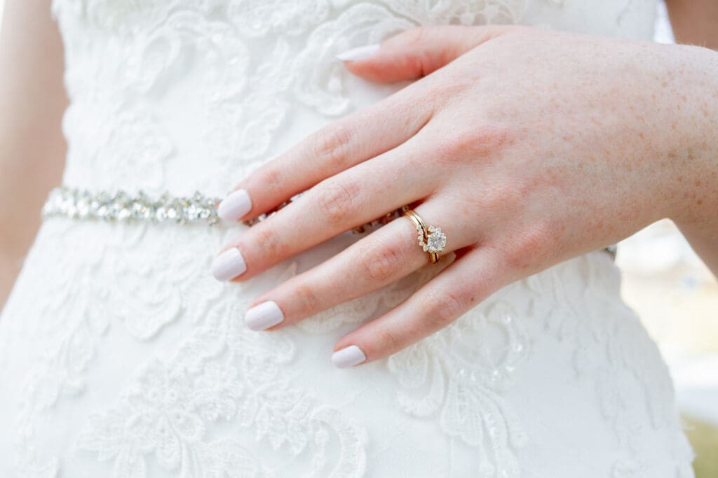 PNW Elopement Photographer captures bride placing hand on waist to show engagement ring