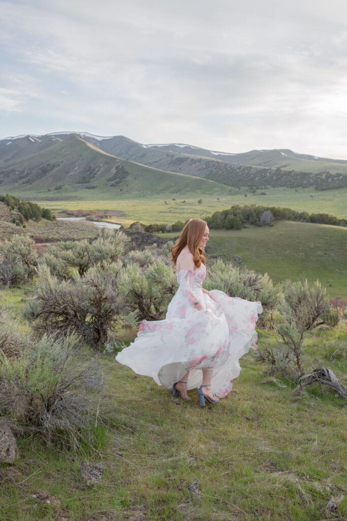 Bride in floral dress spinning around in the mountains captured by Seattle Wedding Photographers