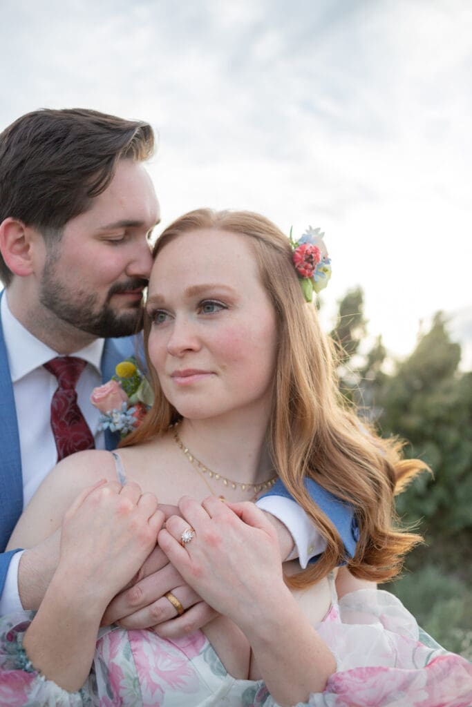 Wedding Photographer in Seattle WA captures an intimate moment between bride and groom with grooms arms wrapped around bride