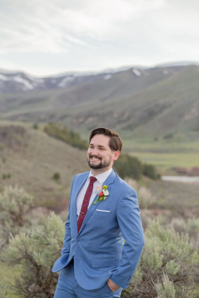 Seattle Destination Wedding groom captured by a wedding photographer in Seattle WA with mountain backdrop