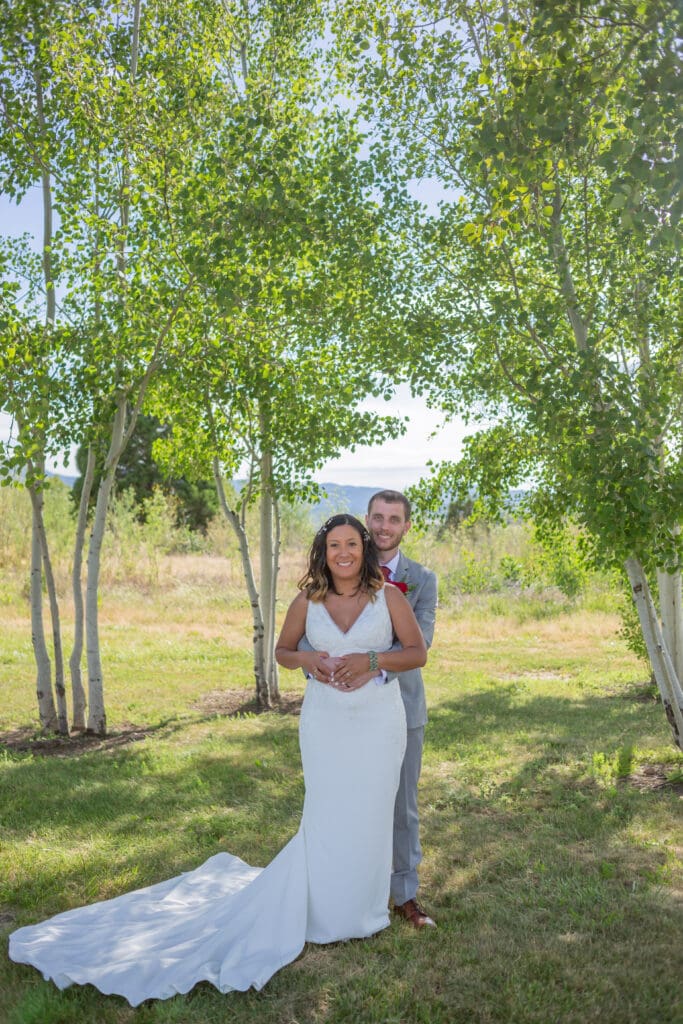 Seattle Wedding Photographer captures couple wrapped in each others arms in a grove of trees